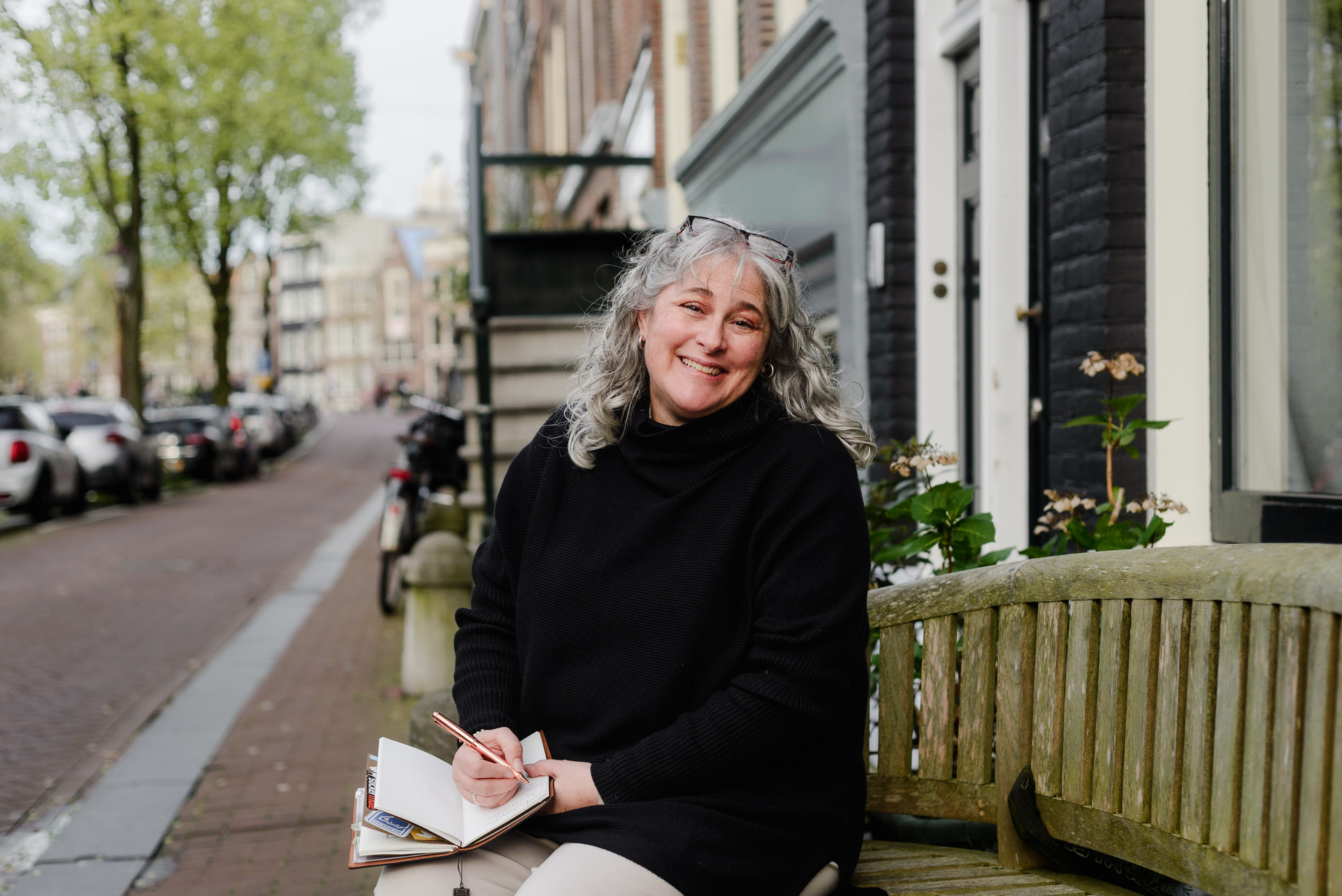 Joanna Pantigoso interviewing a business owner in Amsterdam