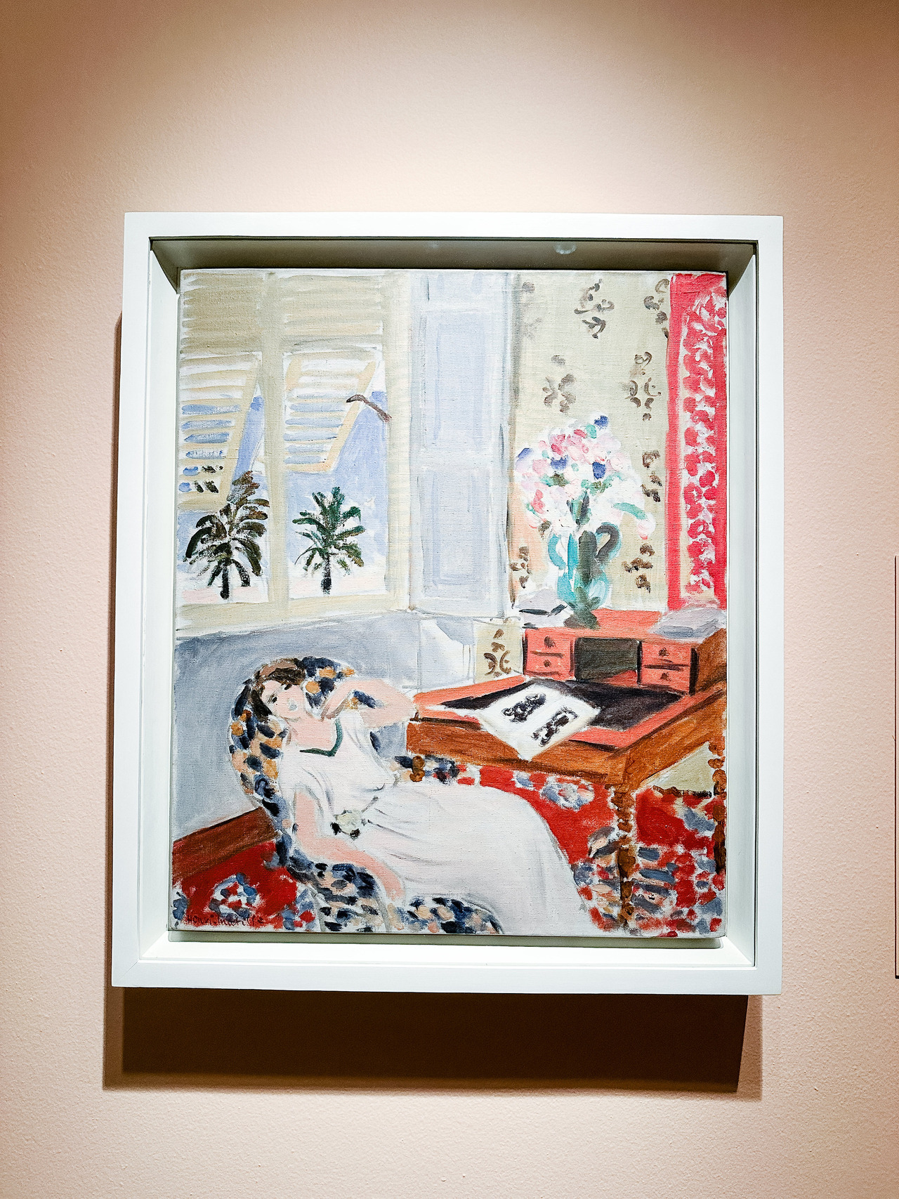 Interior at Nice, the Siesta by Henri Matisse, 1922, showing a woman resting in a softly painted room with open windows and palm trees outside.