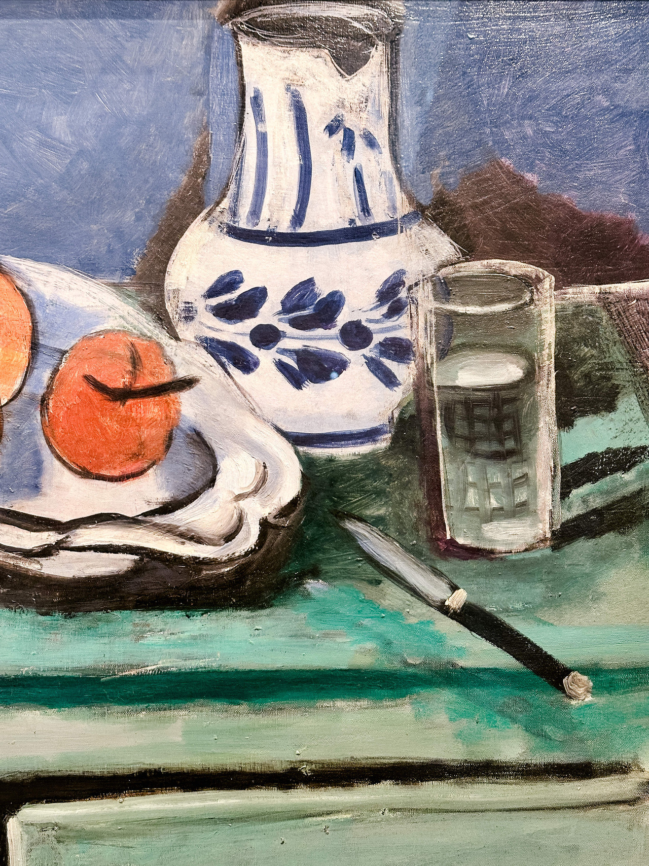 Detail of Henri Matisse’s Still Life with Green Sideboard, 1928, showing fruit and objects on a table.