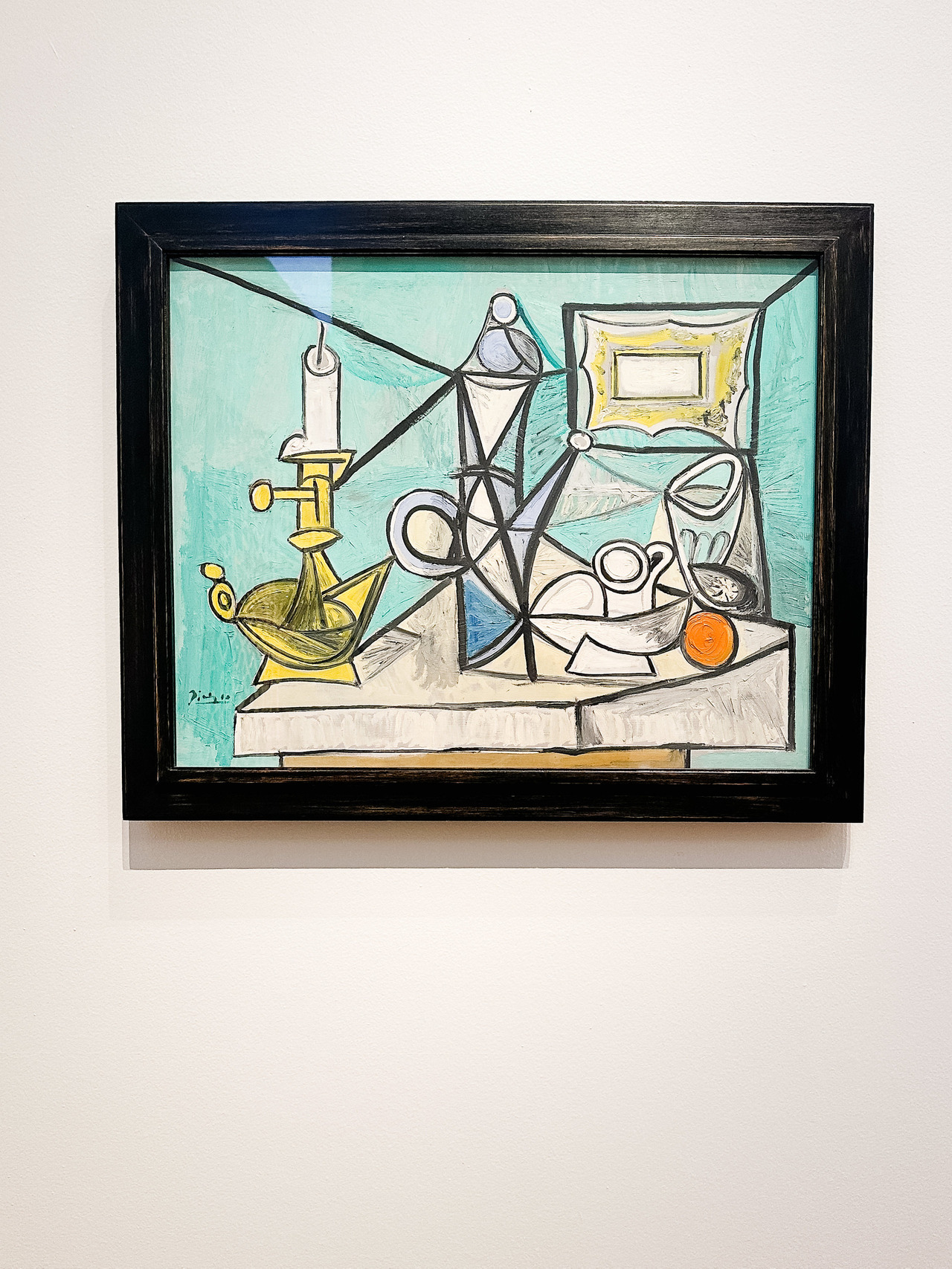 Still Life with Candlestick by Pablo Picasso, 1944, with fruit and table objects divided by strong black lines.