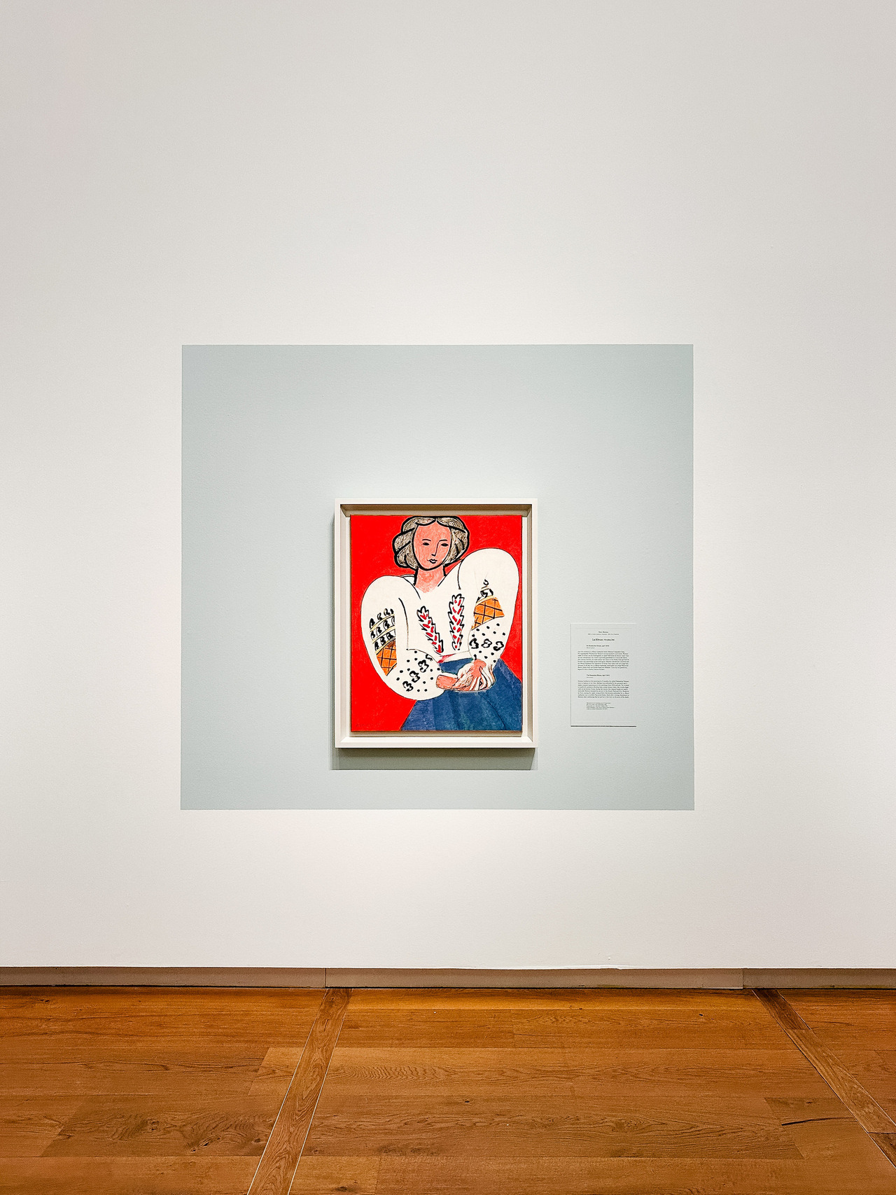 The Romanian Blouse by Henri Matisse, 1940, showing a seated woman in a patterned white blouse against a colourful background.