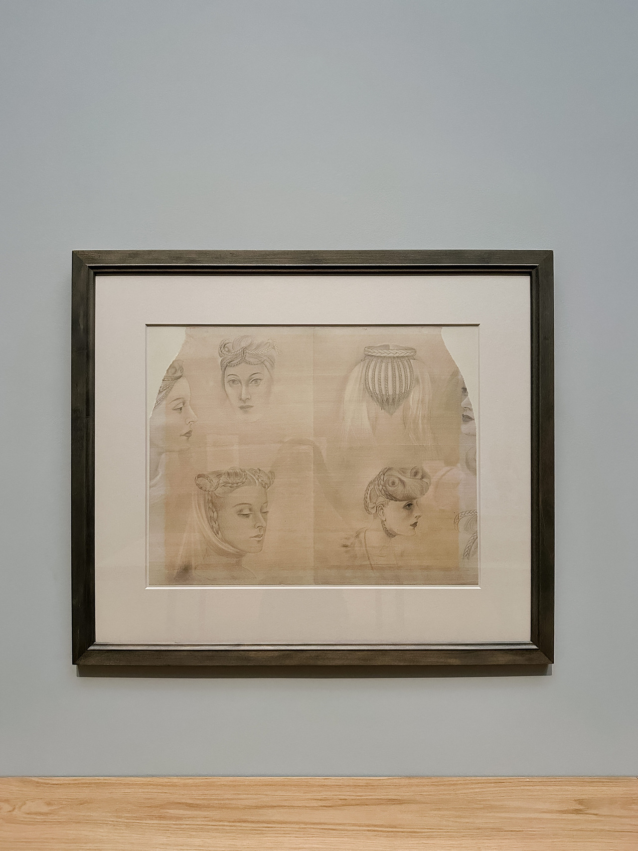 Framed Willem de Kooning drawing with several softly sketched female faces and figures.