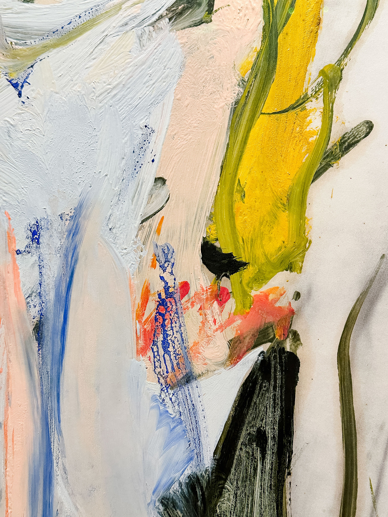 Close-up of thick white, yellow, green and pale pink paint in a Willem de Kooning artwork.