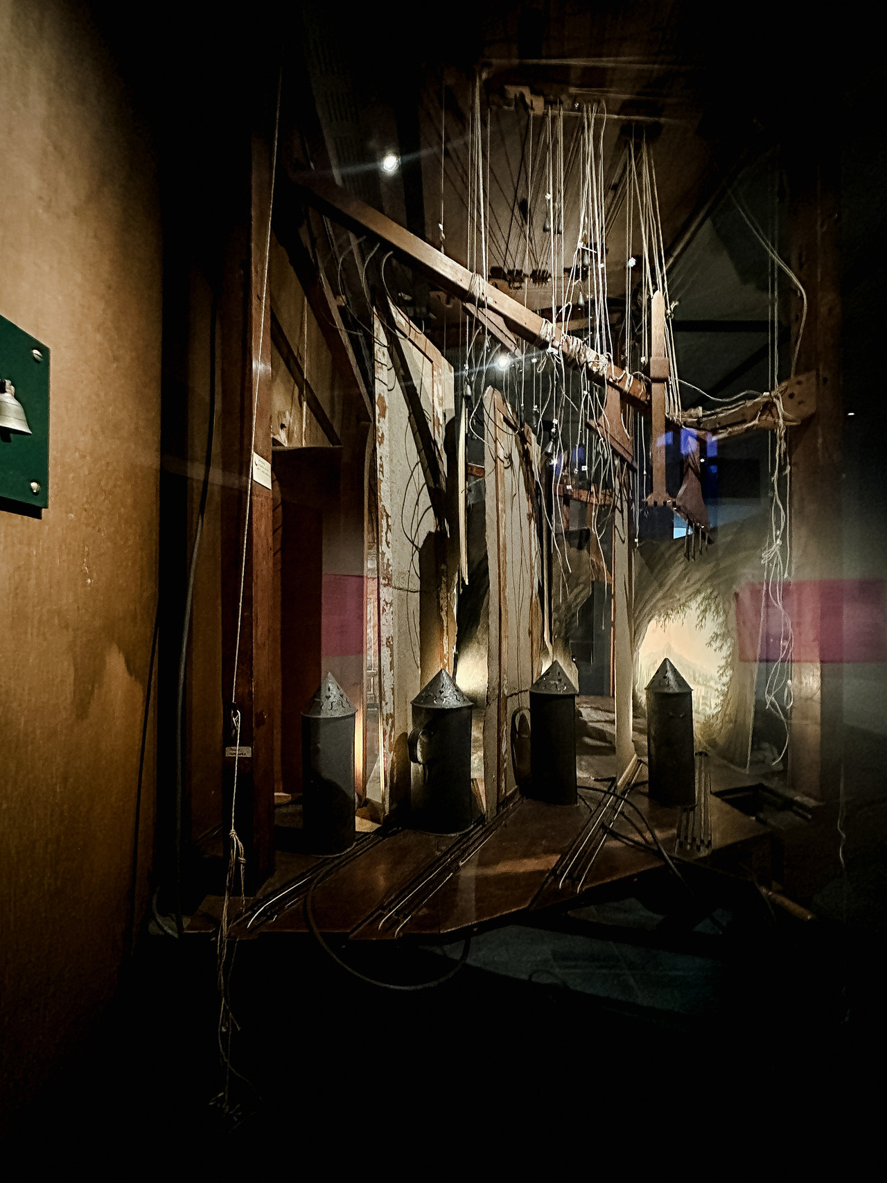 Backstage machinery of the historic Slingelandt chamber theatre, showing wooden beams, hanging ropes, stage rails and painted scenery.