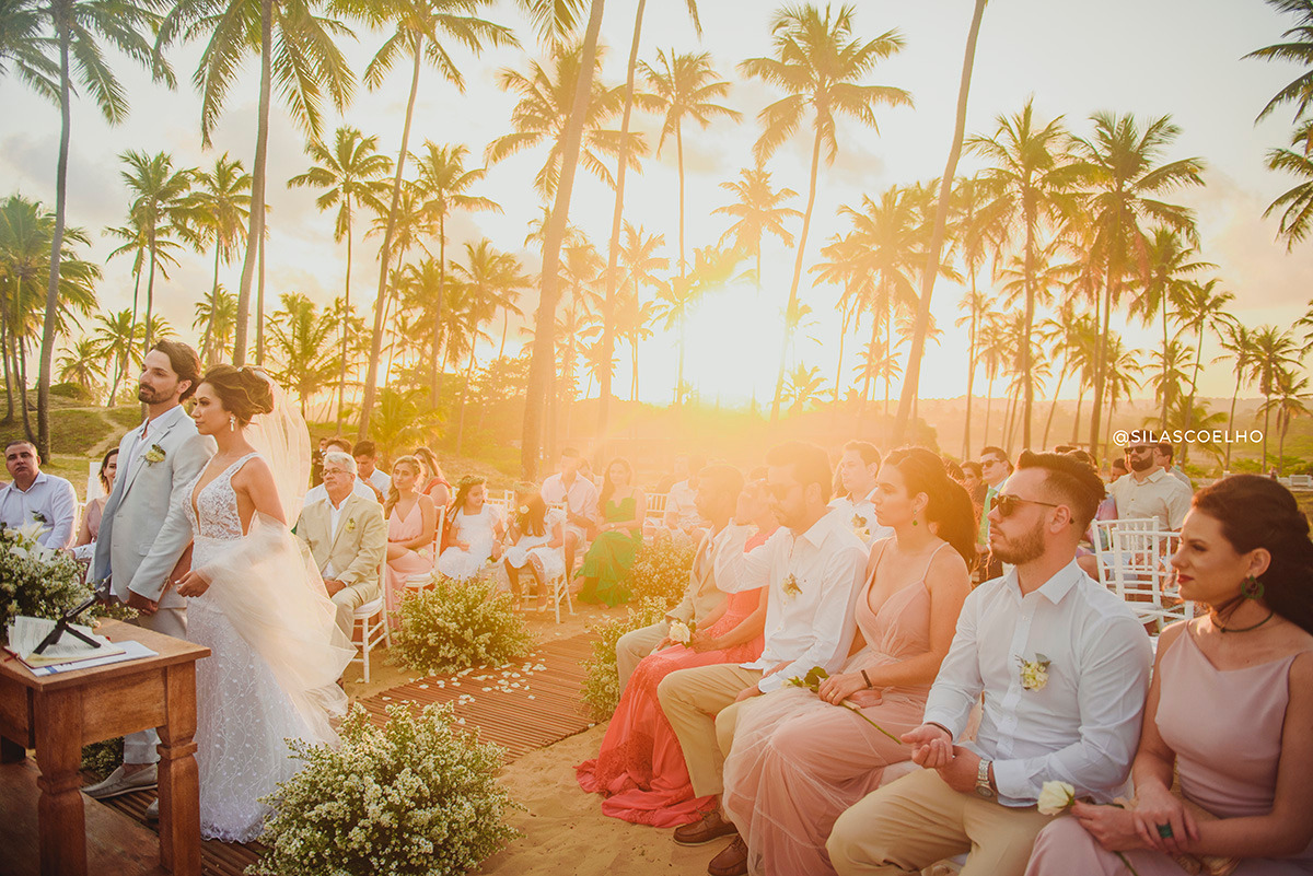 Noivos na ceriônia de casamento. Destination Wedding na praia e no pôr do sol