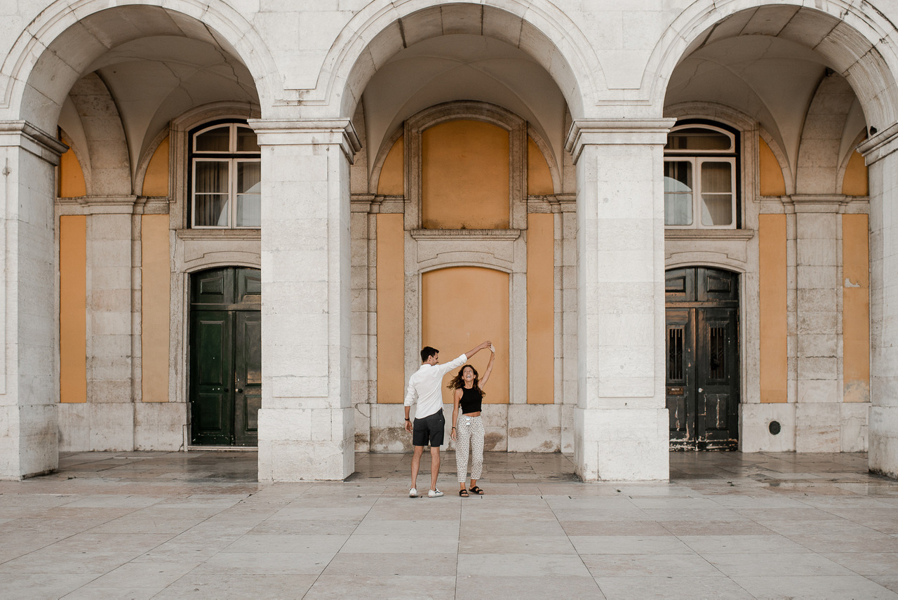 Couple celebrating their engagement at Terreiro do Paço, Lisbon, Portugal