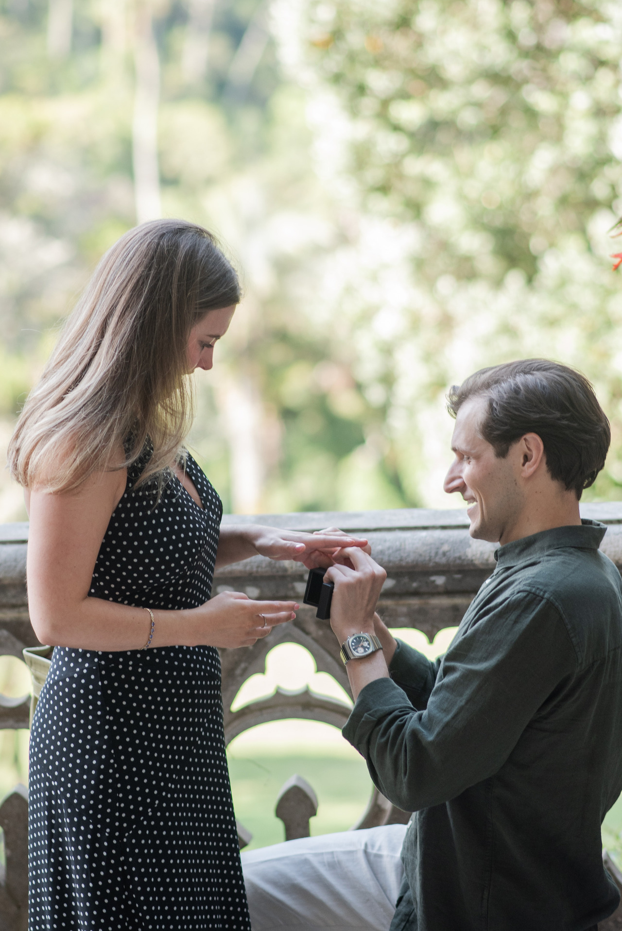 Catherine looks at the ring as Zach proposes on one knee at Palácio de Monserrate, Sintra, proposal photography by Mariana Castanheira