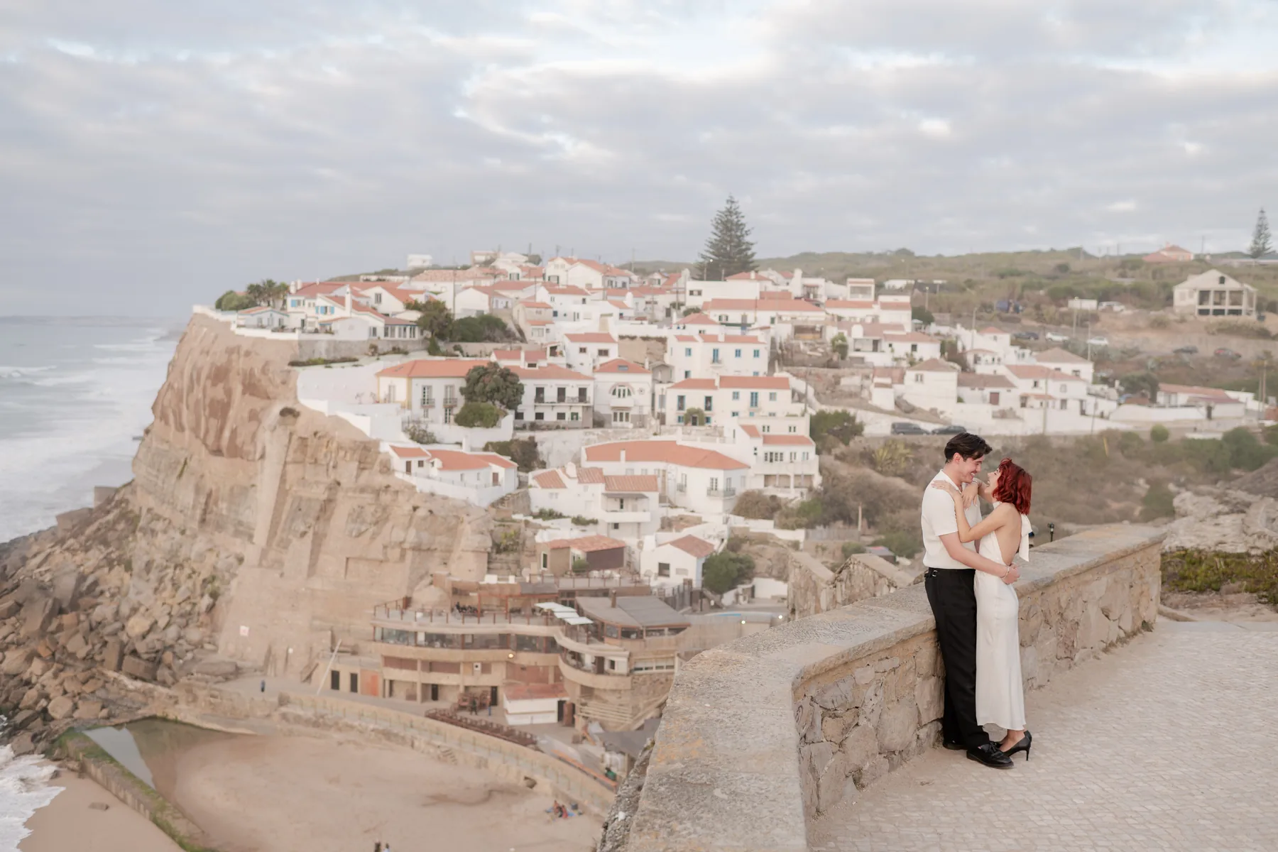 Couple at the viewpoint above the white village and cliff of Azenhas do Mar, Sintra proposal photography by Mariana Castanheira