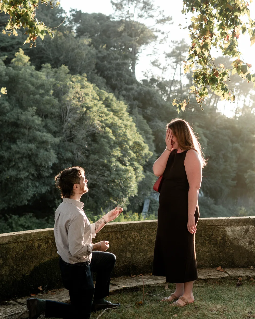 Surprise proposal on one knee at a viewpoint in the gardens of Palácio de Seteais, Sintra proposal photography by Mariana Castanheira