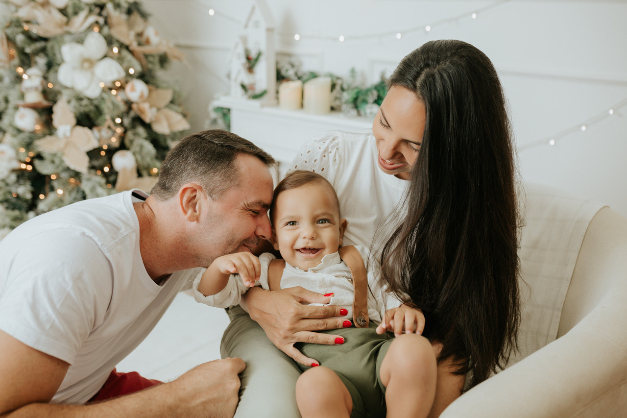 Menina sentada na poltrona, arrumada com temática natalina.