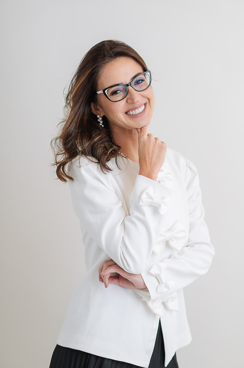 Retrato profissional feminino com blazer branco e óculos no estúdio Dani Justus, Rio de Janeiro