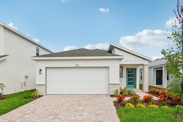 Winter Haven new-construction front exterior with garage, turquoise entry door and neighboring homes.